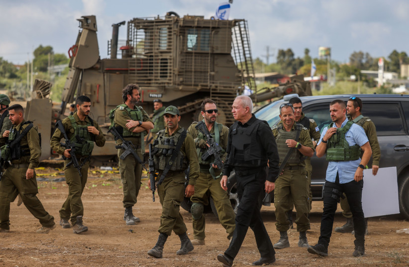 Defense Minister Yoav Gallant speaks with Israeli soldiers at a staging area not far from the Israeli-Gaza border, October 19, 2023