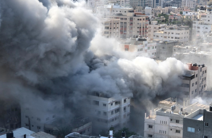 Smoke rises following a blast amid the ongoing conflict between Israel and Hamas, in Gaza City, October 18, 2023, as seen in this screen grab taken from a handout video. (credit: Palestinian Media Group/Handout via REUTERS )