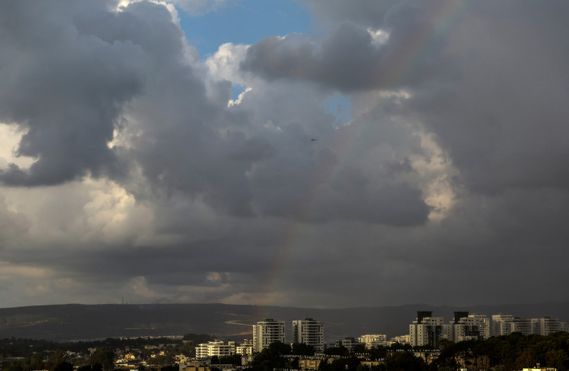 An Israeli military Apache helicopter flies near Israel's border with Lebanon while a rainbow seen in the sky in northern Israel, October 19, 2023 (credit: LISI NIESNER/ REUTERS)