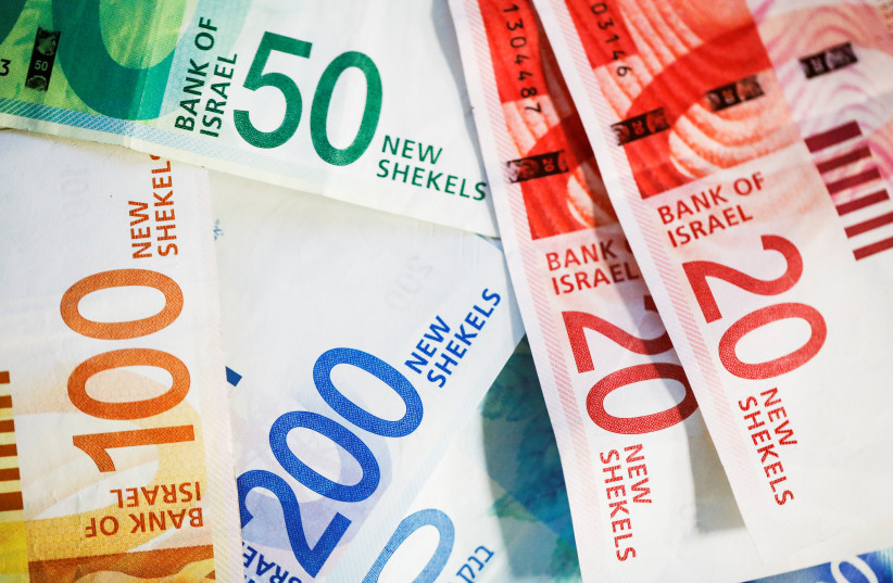  New Israeli Shekel banknotes are seen in this picture illustration taken November 9, 2021. (credit: REUTERS/Nir Elias/Illustration/File Photo)