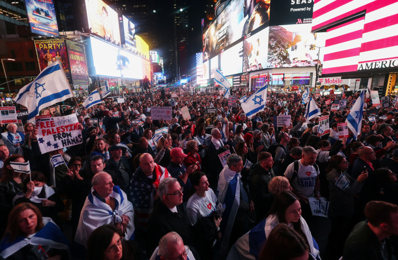 People gather for a demonstration at Times Square to express solidarity with Israel, amid the ongoing conflict between Israel and the Palestinian Islamist group Hamas, in New York City, U.S., October 19, 2023. (credit: Mike Segar/Reuters)