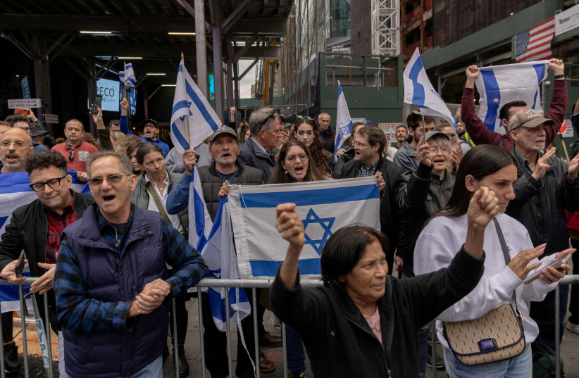 Pro-Israel demonstrators protest in Times Square on the second day of the ongoing conflict between Israel and the Palestinian terrorist group Hamas, in Manhattan in New York City, U.S., October 8, 2023. (credit: JEENAH MOON/REUTERS)