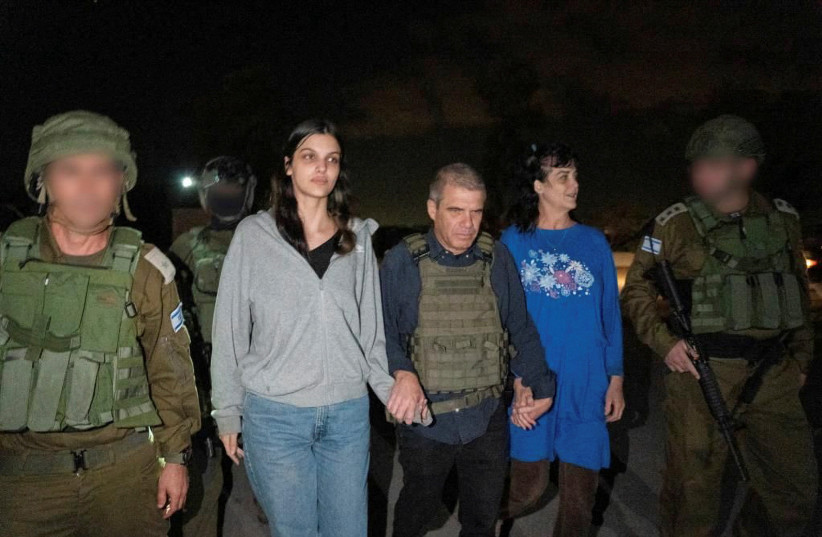  Judith Tai Raanan and her daughter Natalie Shoshana Raanan, US citizens who were taken as hostages by Palestinian Hamas militants, walk while holding hands with Brig.-Gen. (Ret.) Gal Hirsch, Israel's Coordinator for the Captives and Missing, after they were released by the militants. (credit: Government of Israel/Handout via REUTERS)