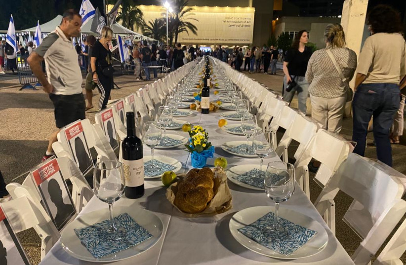  An empty Shabbat table laid for those taken hostage by Hamas, October 2023 (credit: AVSHALOM SASSONI/MAARIV)