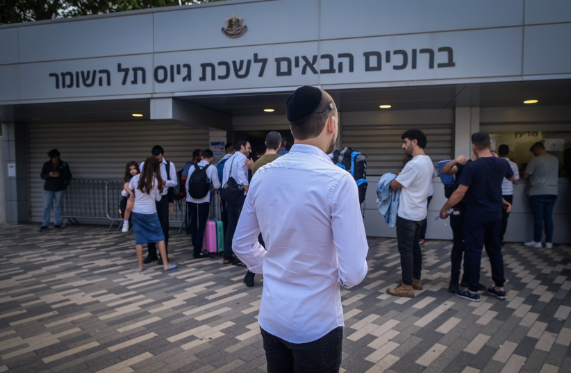  Ultra-Orthodox Jewish men who decided to join in the IDF following the ongoing war between Israel and Hamas arrive at the IDF recruiting offices in Tel Hashomer, near Tel Aviv, October 23, 2023 (credit: AVSHALOM SASSONI/FLASH90)