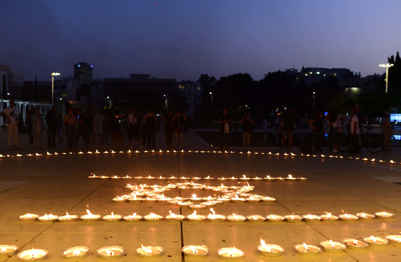  Musicians from the Israeli Philharmonic Orchestra seen performing next to lit candles in an event at haBima square in memory of the more than 1300  killed by Hamas terrorists, and more than 200 held hostage in Gaza.   October 22, 2023. (credit: TOMER NEUBERG/FLASH90)
