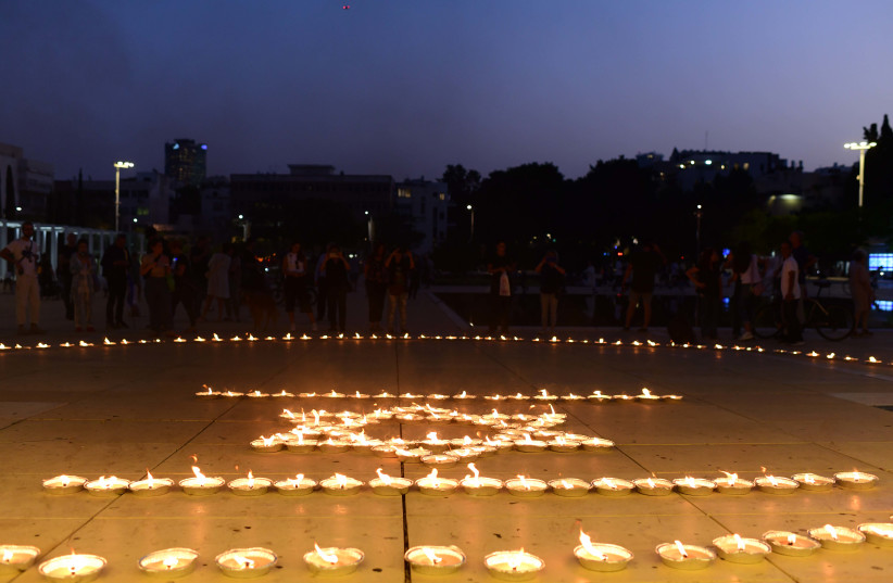 Musicians from the Israeli Philharmonic Orchestra seen performing next to lit candles in an event at haBima square in memory of the more than 1300 killed by Hamas terrorists, and more than 200 held hostage in Gaza.  October 22, 2023.