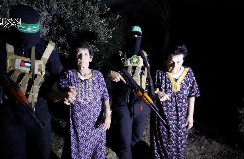 Yocheved Lifshitz and Nurit Cooper (also known as Nurit Yitzhak) who were held hostages by Palestinian Hamas militants, are released by the militants, in this video screengrab obtained by Reuters on October 23, 2023. (credit: Al-Qassam Brigades via REUTERS)
