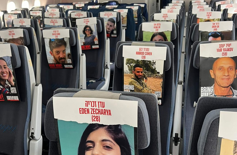  Photos of Israelis kidnapped by Hamas in Gaza fill empty seats on an El Al flight carrying military and medical equipment to Israel, October 23 2023. (credit: EL AL)