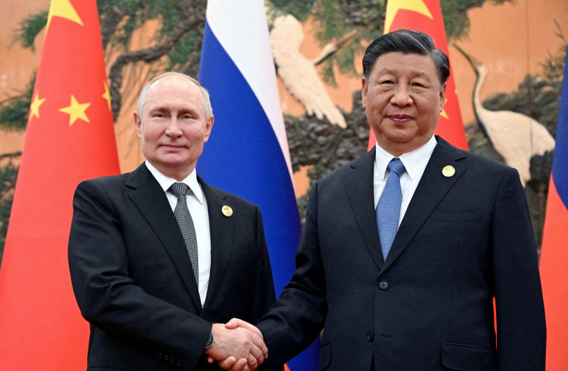 Russian President Vladimir Putin shakes hands with Chinese President Xi Jinping during a meeting at the Belt and Road Forum in Beijing, China, October 18, 2023.  (credit: Sputnik/Sergei Guneev/Pool via REUTERS)