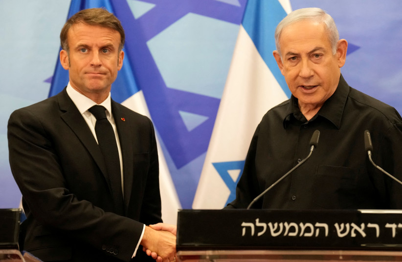  Israeli Prime Minister Benjamin Netanyahu and French President Emmanuel Macron shake hands at a joint press conference, amid the Israeli-Hamas conflict, in Jerusalem, October 24, 2023 (credit: CHRISTOPHE ENA/POOL VIA REUTERS)