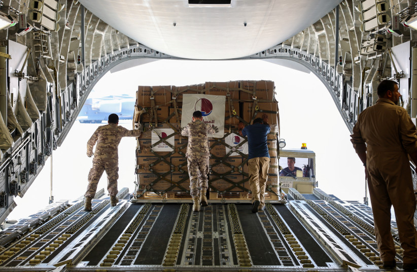  Qatari Amiri Air Force crew load food and medical aid to their cargo plane from the Qatar Fund for Development headed to Egypt for Gaza, at Al Udeid Air Base, Doha, Qatar, October 16, 2023. (credit: QATAR NEWS AGENCY/HANDOUT VIA REUTERS)