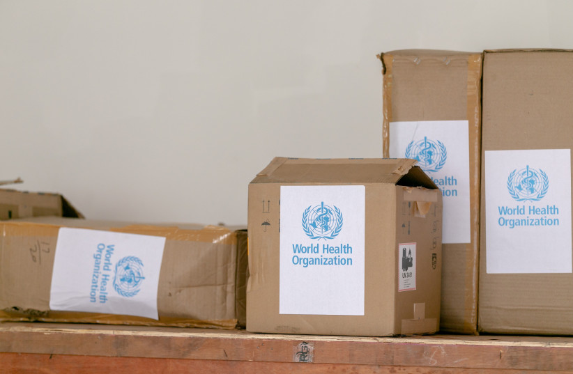  Cardboard boxes with World Health Organization stickers on them.. (credit: PEXELS)
