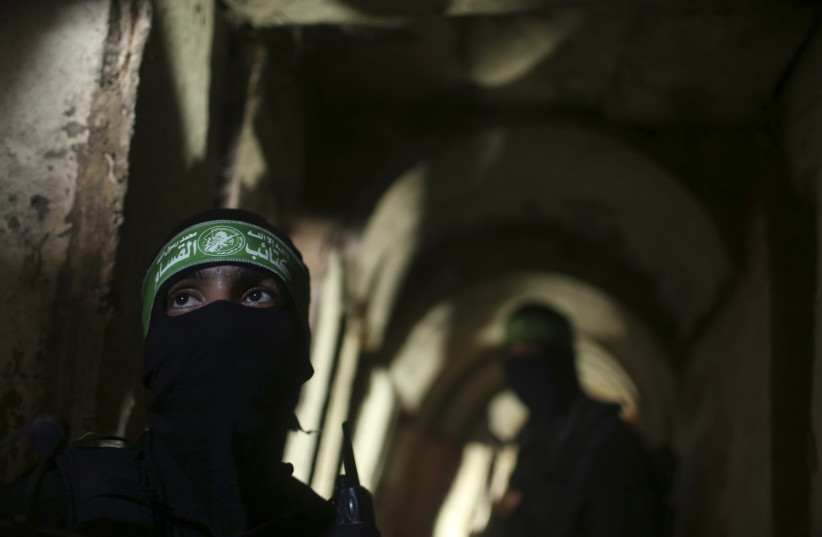Palestinian terrorists from the Izz el-Deen al-Qassam Brigades, the armed wing of the Hamas movement, stand inside an underground tunnel in Gaza August 18, 2014.