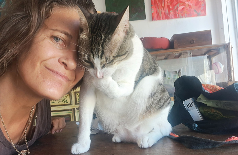  DANNI WITH her one-eyed rescue cat, Tiny, whom she adopted at a few days old after the city municipality removed the cat from an abusive home. (credit: Danni Meyerson)