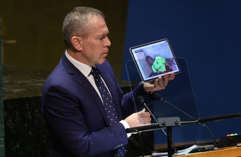  Israel's Ambassador to the United Nations Gilad Erdan shows a video on a portable device as he speaks to an emergency special session of the United Nations General Assembly on the ongoing conflict between Israel and Hamas at U.N. headquarters in New York City, U.S., October 26, 2023. (credit: REUTERS/MIKE SEGAR)