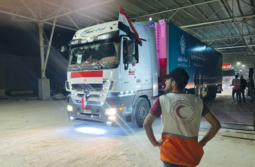  UMANITARIAN AID crosses from Egypt to Gaza, at the Rafah crossing, this week. Hamas belligerence has led to an Egyptian and Israeli attempt to control what comes into Gaza. Does that make it an open-air prison?  (credit: Palestine Red Crescent Society/Reuters)