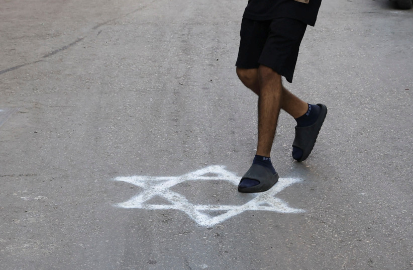  A person steps on a graffiti of the Star of David sprayed on a pavement in Bourj al-Barajneh Refugee Camp in Beirut, Lebanon, October 25, 2023 (credit: REUTERS/AMR ALFIKY)