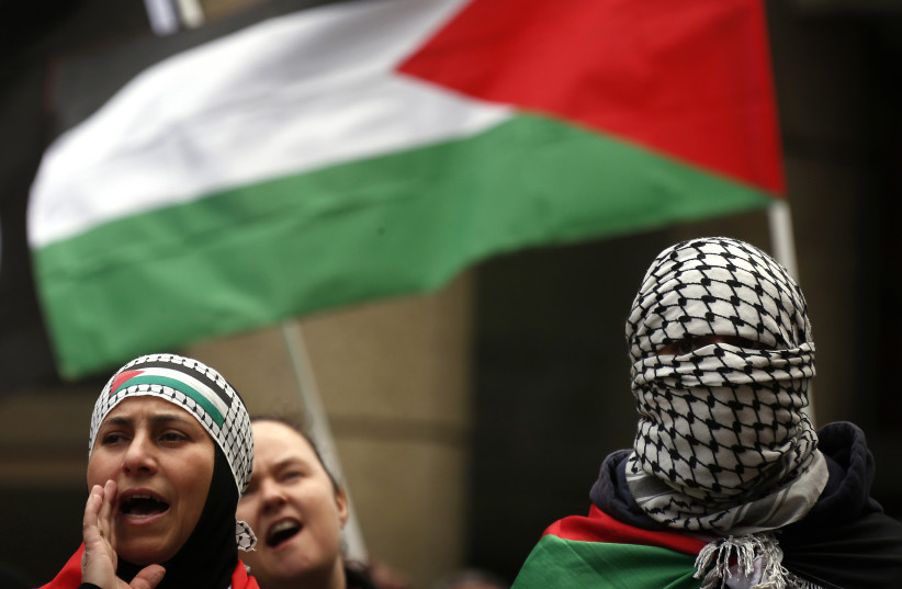  Members of the Australian Palestinian community holds flags and chant slogans as they participate in a protest against Israel's military action in Gaza, in Sydney July 20, 2014. (credit: REUTERS/DAVID GRAY)