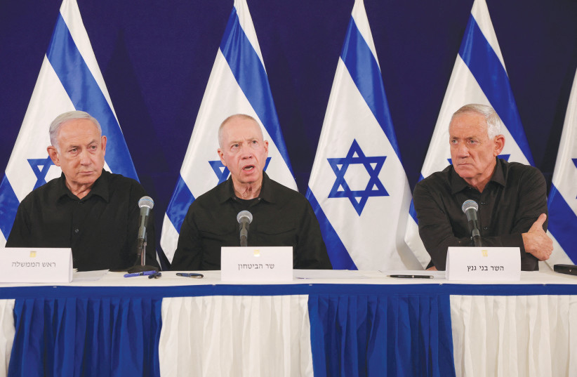  Prime Minister Benjamin Netanyahu, with Defense Minister Yoav Gallant and MKo Benny Gantz, holds a news conference in Tel Aviv on Saturday night. (credit: Abir Sultan/Reuters)