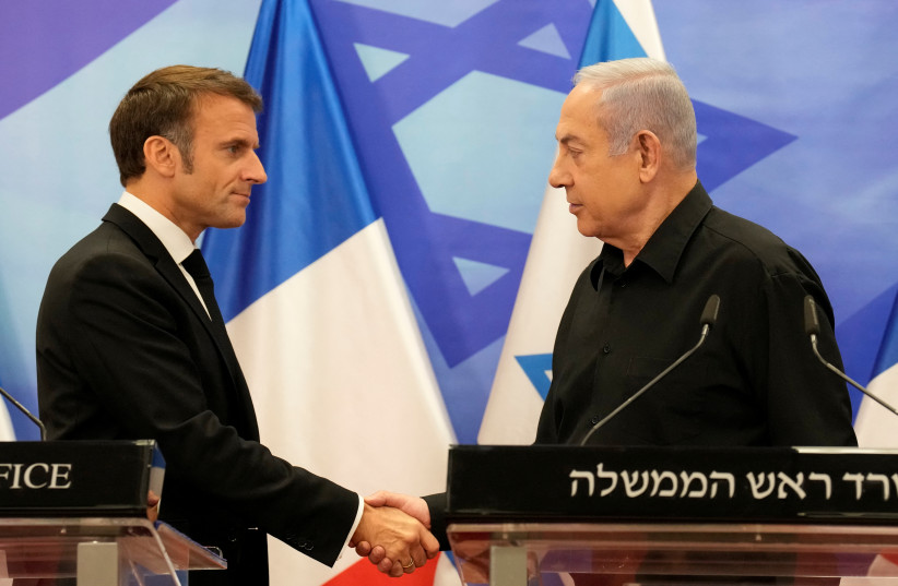  Israeli Prime Minister Benjamin Netanyahu and French President Emmanuel Macron shake hands at a joint press conference, amid the Israeli-Hamas conflict, in Jerusalem, October 24, 2023. (credit: CHRISTOPHE ENA/POOL VIA REUTERS)
