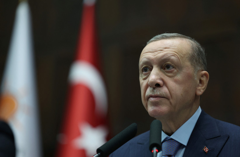 Turkish President Tayyip Erdogan addresses members of parliament from his ruling AK Party (AKP) during a meeting at the Turkish parliament in Ankara, Turkey, October 25, 2023.  (credit: MURAT CETINMUHURDAR/PPO/HANDOUT VIA REUTERS)