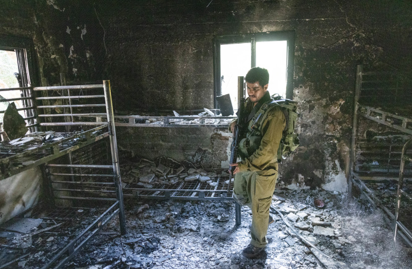  Israeli soldier around the destruction caused by Hamas terrorists in Kibbutz Nir Oz on October 7, 2023, near the Israeli-Gaza border, in southern Israel, October 30, 2023 (credit: Chaim Goldberg/Flash90)