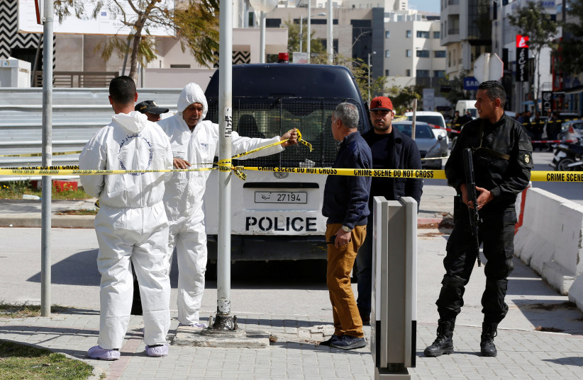  Forensic experts and a police officer are seen at the site of a suicide attack near the U.S. embassy in Tunis, Tunisia March 6, 2020. (credit: REUTERS/ZOUBEIR SOUISSI)