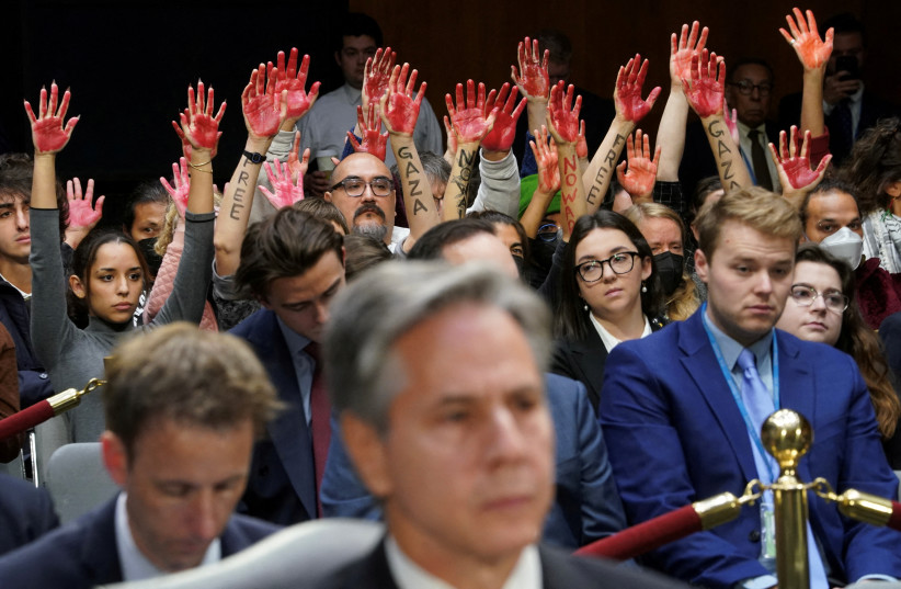  Anti-war protesters raise their ''bloody'' hands behind US Secretary of State Antony Blinken during a Senate Appropriations Committee hearing on President Biden's $106b. national security supplemental funding request to support Israel and Ukriane, on Capitol Hill in Washington, US, October 31, 2023. (credit: KEVIN LAMARQUE/REUTERS)