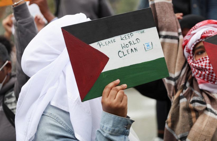A person holds a sign during a demonstration to express solidarity with Palestinians in Gaza, amid the ongoing conflict between Israel and Hamas, as part of a student walkout by students of New York University, in New York City, US, October 25, 2023.  (credit: Shannon Stapleton/Reuters)