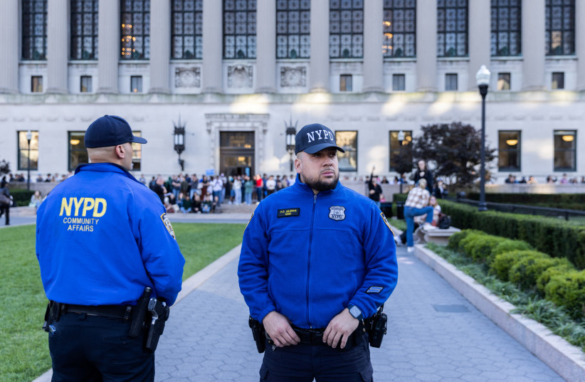 New York police officers stand guard as pro-Israel and pro-Palestinians students demonstrate, amid the ongoing conflict in Gaza, at Columbia University in New York City, US, October 12, 2023 (credit: JEENAH MOON/REUTERS)