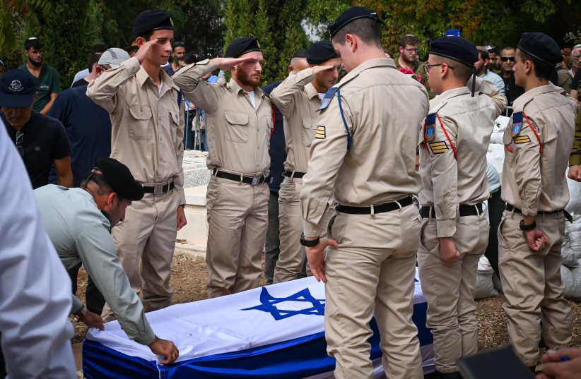  Family and friends attend the funeral of Sgt. Shoam Moshe Ben-Harush who died of his wounds after being severely injured in the Hamas terrorist on October 7, 2023, at the Haspin cemetery in northern Israel, on October 27, 2023. (credit: MICHAEL GILADI/FLASH90)