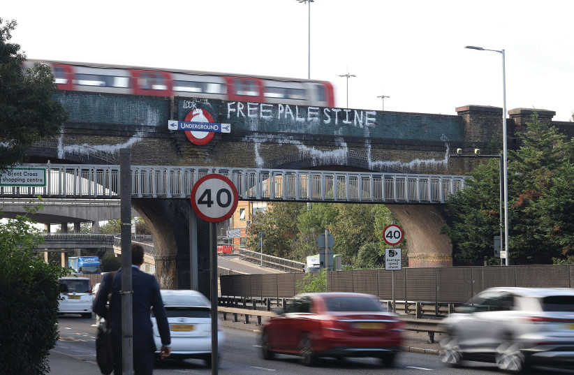  A LONDON UNDERGROUND train bridge daubed with ‘Free Palestine’ graffiti near Brent Cross Shopping Centre in north London last month. (credit: Anna Gordon/REUTERS)
