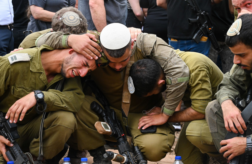  Family and friends attend the funeral of Sgt. Shoam Moshe Ben-Harush who died of his wounds after being severely injured in the Hamas terrorist on October 7, 2023, at the Haspin cemetery in northern Israel, on October 27, 2023 (credit: MICHAEL GILADI/FLASH90)