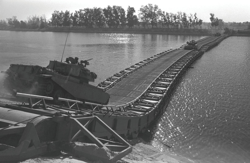  ‘THE YOM Kippur War was a picnic compared to this one’: Iconic shot of IDF tank crossing a bridge built by Israeli troops over the Suez Canal, Oct. 25, 1973 (credit: Ilan Ron/GPO/Getty Images)