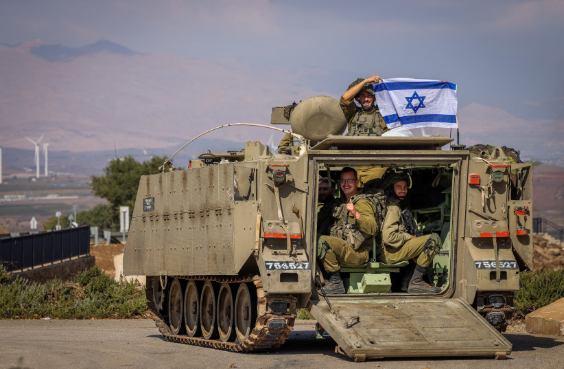  Israeli soldiers with Israeli flags near the Israeli border with Lebanon, northern Israel, November 2, 2023 (credit: David Cohen/Flash90)