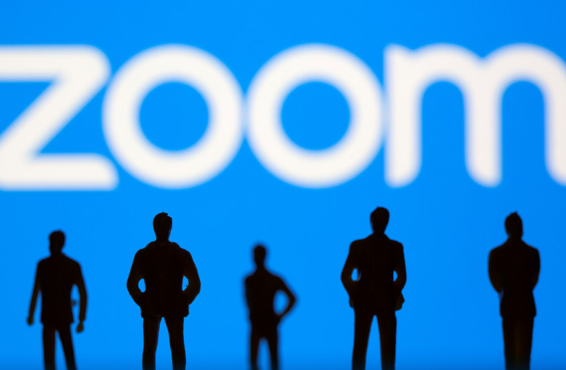  Small toy figures are seen in front of Zoom logo in this illustration picture taken March 15, 2021. (credit: REUTERS/DADO RUVIC/ILLUSTRATION)