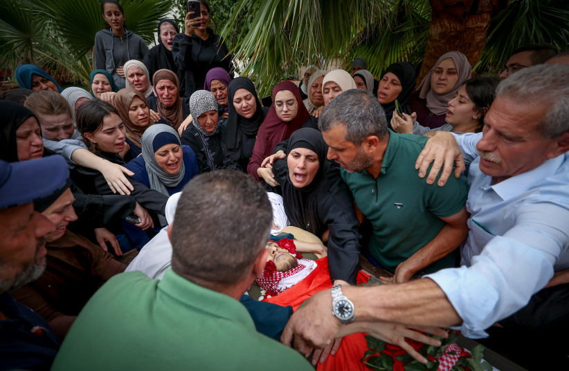  Palestinians mourn Nasser Barghouti during his funeral in the West Bank village of Beit Rima, northwest of Ramallah, Sunday, Oct. 29, 2023. Barghouthi was killed during an Israeli army raid in Bait Reema early morning, the Palestinian Ministry of Health said (credit: FLASH90)