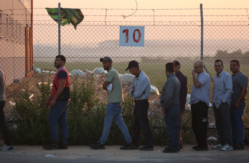  Palestinian workers stand in line at the reopened Erez crossing to Israel, after Israel ends a ban on workers from Gaza, in Gaza City, on September 28, 2023. (credit: ATIA MOHAMMED/FLASH90)