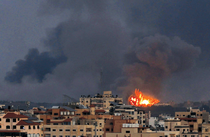  Explosions are seen following Israeli airstrikes in Gaza City on October 10 (credit: MOHAMMED SALEM/REUTERS)