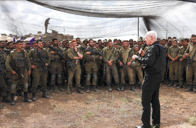  Defense Minister Yoav Gallant meets soldiers in a field near Israel's border with the Gaza Strip on October 19, 2023 (credit: RONEN ZVULUN/REUTERS)