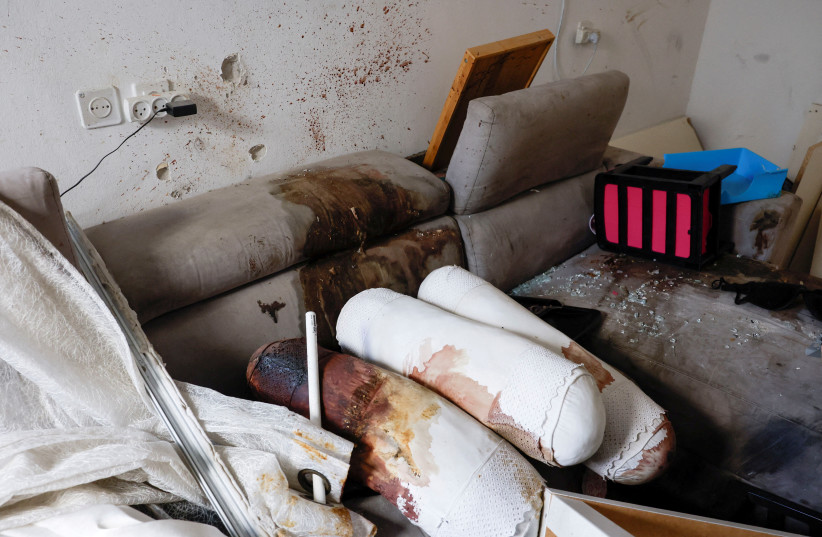  Pillows covered in blood lie on the couch in a destroyed home, following the deadly October 7 attack by Hamas gunmen from the Gaza Strip, in Kibbutz Kfar Aza, southern Israel November 2, 2023.  (credit: EVELYN HOCKSTEIN/REUTERS)