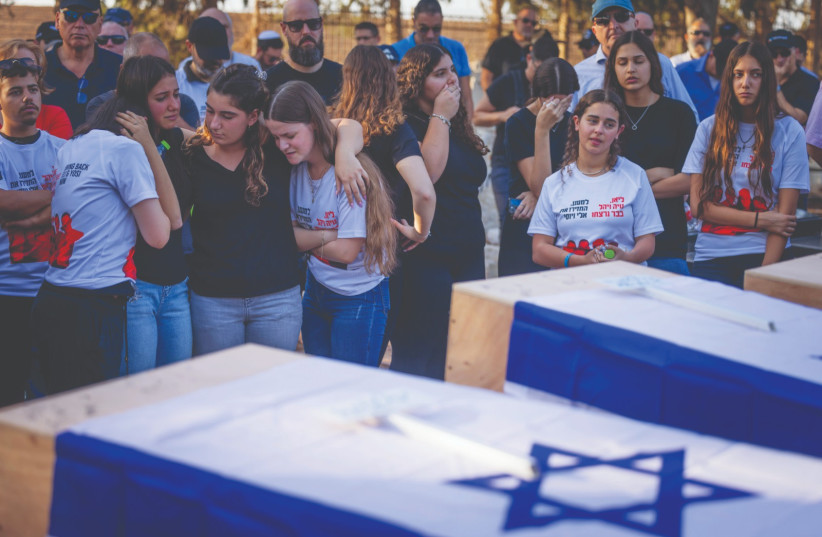  THE OCT. 25 funeral of three members of the Sharabi family – Lian, Noya and Yahel – murdered in Kibbutz Be’eri on Oct. 7 (credit: Chaim Goldberg/Flash90)