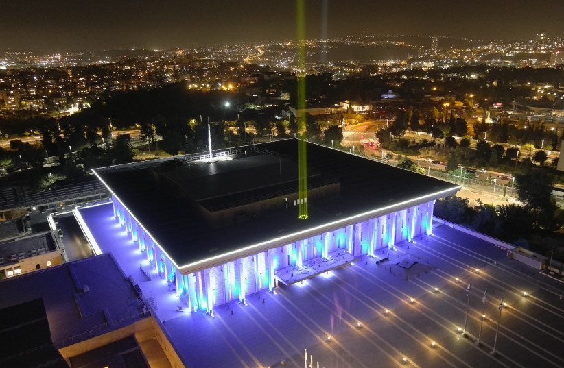 Knesset shines a yellow beam to represent the hostages being kept by Hamas in Gaza, November 7, 2023