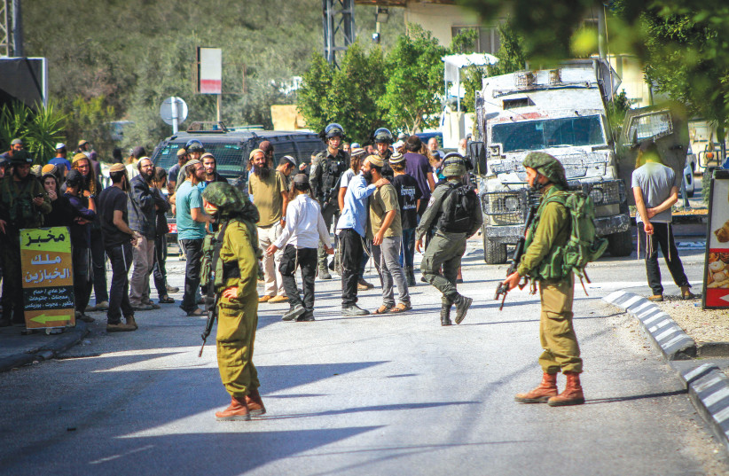  IDF SOLDIERS prevent settlers from entering the village of Deir Sharaf, west of Nablus, in response to a shooting attack last Thursday. (credit: NASSER ISHTAYEH/FLASH90)