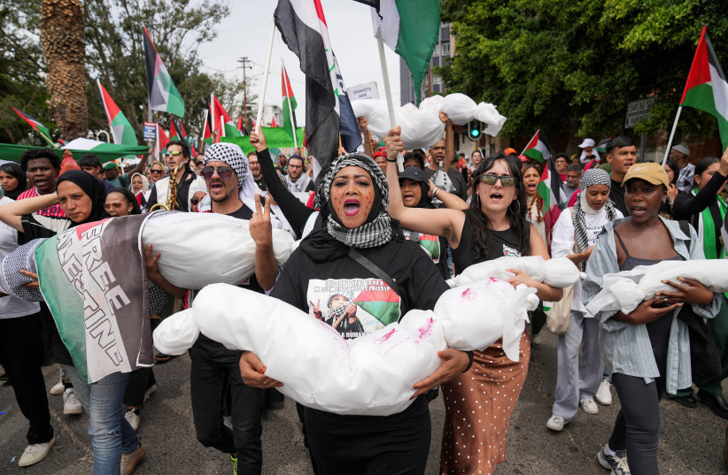  Demonstrators carry fake bodies wrapped in cloth during a protest in support of Palestinians, as they march to the Cape Town City Hall, amid the ongoing conflict between Israel and Palestinian Islamist group Hamas, in Cape Town, South Africa November 1, 2023. (credit: Nic Bothma/Reuters)