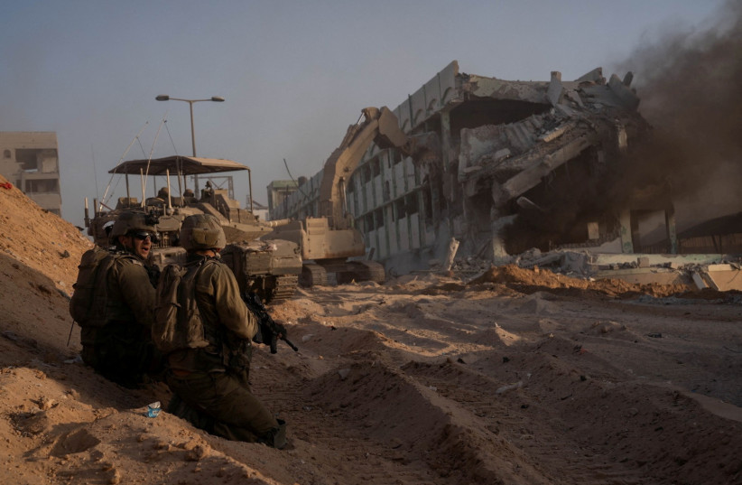  Israeli soldiers hold a position amid the ongoing ground operation of the Israeli army against the Palestinian terrorist group Hamas, in the Gaza Strip, in this handout image released by the Israel Defense Forces on November 8, 2023.  (credit: Israel Defense Forces/Handout via REUTERS)