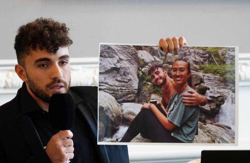  Ofir Tamir holds up a picture of his friend Noa Argamani, who was taken hostage on October 7 by Hamas, as he speaks during a press conference in Copenhagen, Denmark, October 30, 2023. (credit: REUTERS/Tom Little)