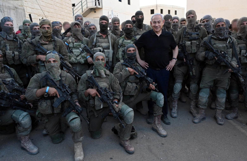  Israeli Prime Minister Benjamin Netanyahu poses for a photo with soldiers as he visits an Israeli army base in Tze'elim, Israel November 7, 2023. (credit: Israeli Government Press Office/Haim Zach/Handout via REUTERS)