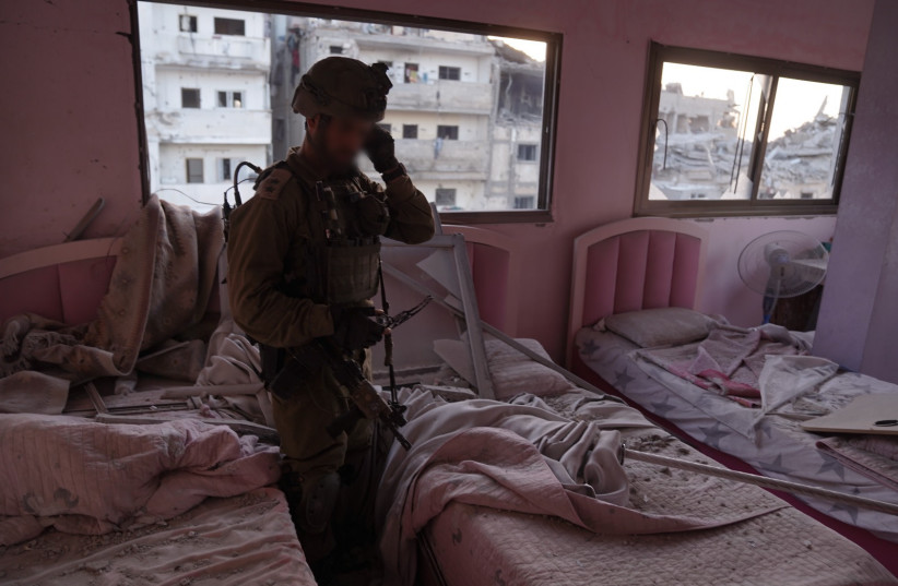 An IDF soldier in a bedroom located next to a Hamas weapons factory in northern Gaza. (credit: IDF SPOKESPERSON'S UNIT)